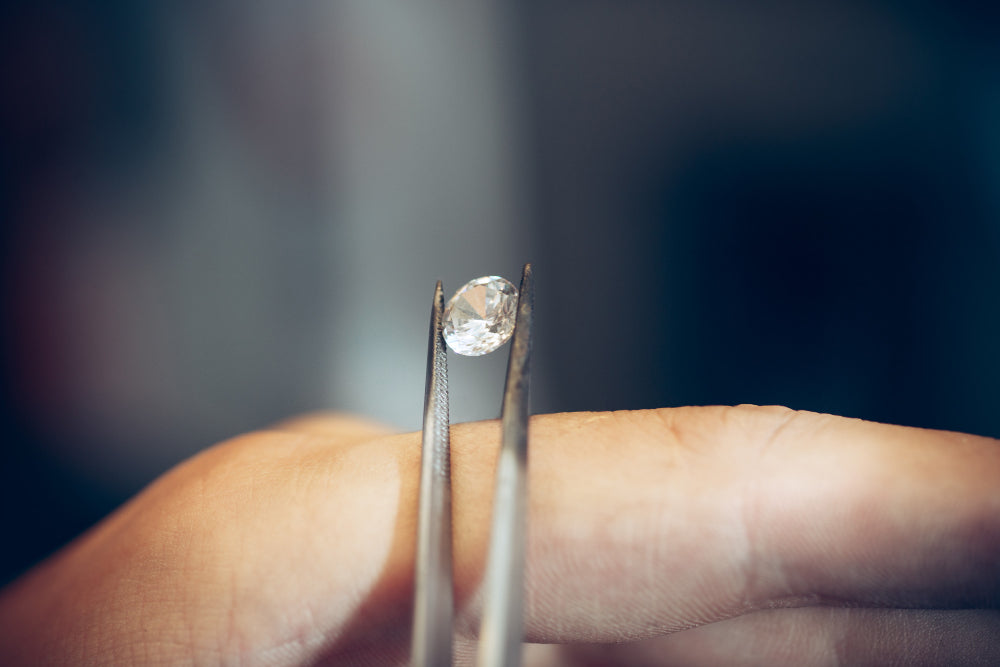 jeweler holding diamond with tweezers